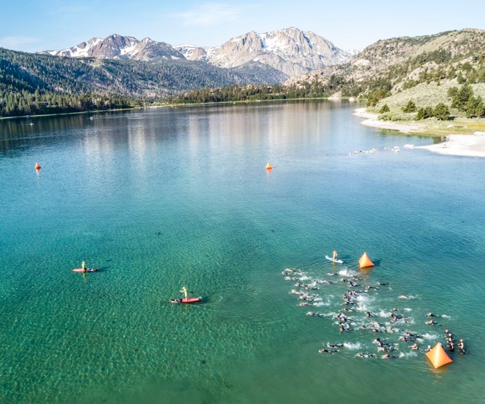 A picture of triathletes swimming in June Lake.